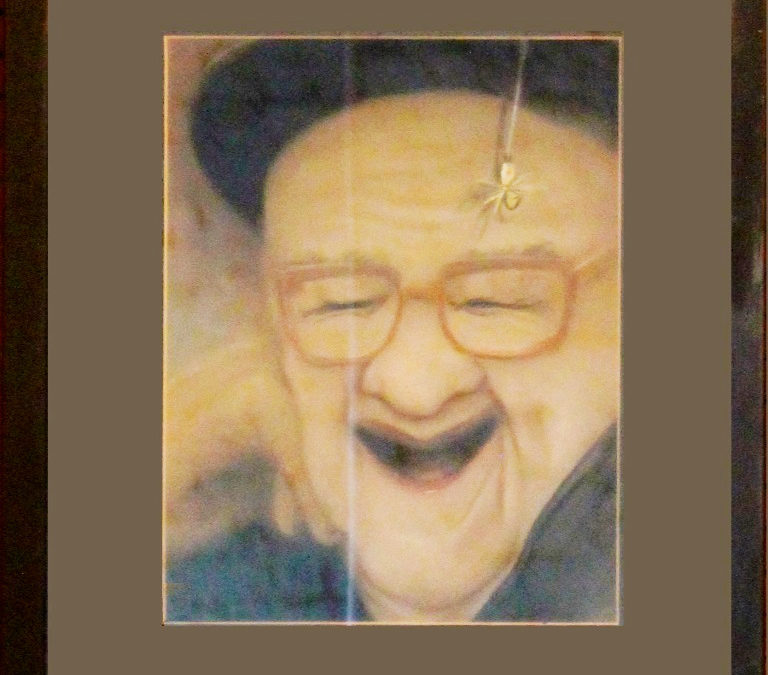 painting of a laughing old man with no teeth. He wears a dark hat with the brim pushed up high on his forhead. His hand is propped on the side of his face and there is a spider hanging down in front of his head.